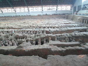 Side view of the Terracotta Army in one of the pits still being excavated. Side view of the Terracotta Army in one of the pits still being excavated.