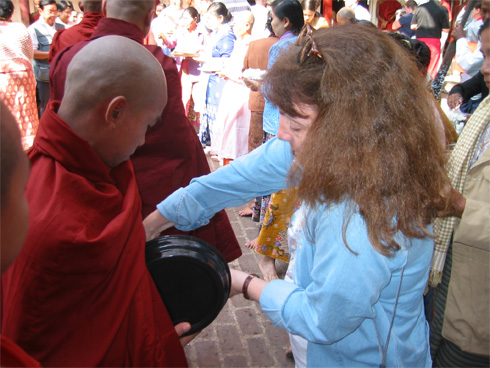 California Native, Ellen Klein, serving rice to monks in Myanmar.