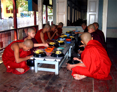 Young monks in Myanmar taking their daily meal Young monks in Myanmar taking their daily meal
