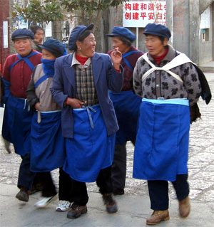 Wearing blue aprons and caps, Chinese ladies go home from work in Yunnan Province/></td>
</tr>
</tbody>
</table>
<table border=