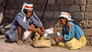 In Mexico's Copper Canyon, a Tarahumara man helps his wife with her chores. In Mexico's Copper Canyon, a Tarahumara man helps his wife with her chores.