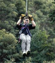 California Native zip lining over the canopy in a Costa Rican rainforest.