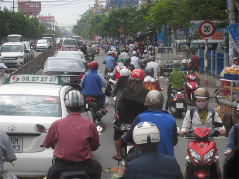 Traffic in Vietnam is a mad melange of motorbikes and cars.