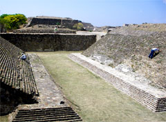 Workers work on restoration of a Mayan ballfield.